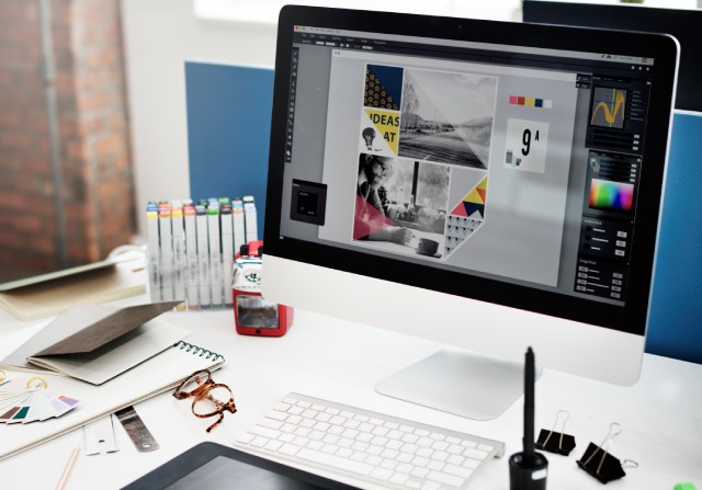 Office desk with computer screen showing brand elements